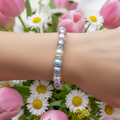 Pastel Pearl Bracelet Wrist Shot with Spring Flowers